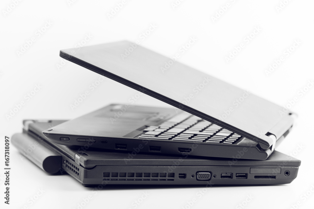 Two Black Laptops One Over Another On White Background Two Black Laptops One Over Another On White Background