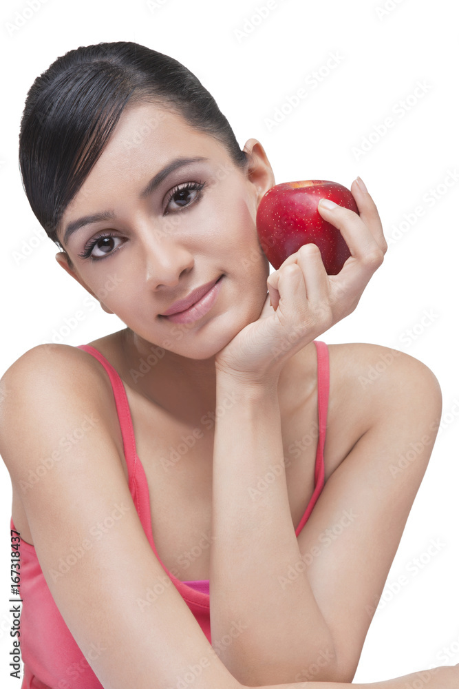 Portrait of beautiful woman with apple over white background Portrait of beautiful woman with apple over white background