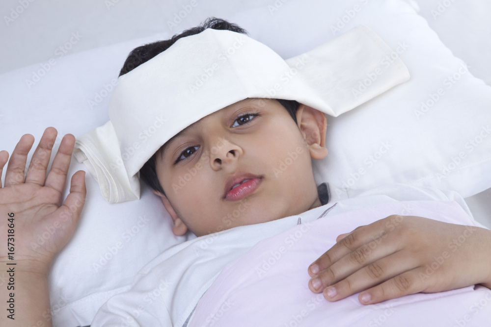 Portrait of a little boy with wet cloth on forehead Portrait of a little boy with wet cloth on forehead