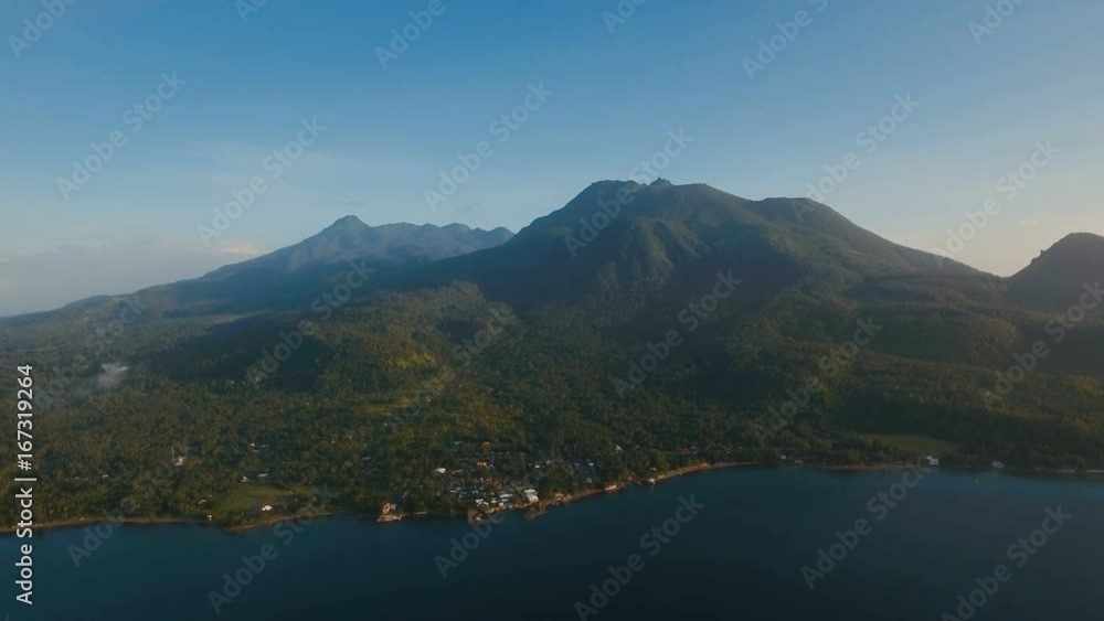 Aerial view coastline on tropical island with sea, trees, palms. Aerial footage. Mountains and hills with wild forest, sky clouds. Aerial video from flying drone of amazingly beautiful landscape with Aerial view coastline on tropical island with sea, trees, palms. Aerial footage. Mountains and hills with wild forest, sky clouds. Aerial video from flying drone of amazingly beautiful landscape with