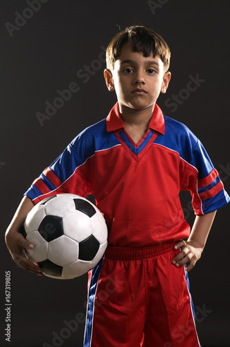 A boy holding a football 