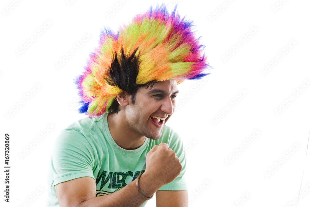 Young man with a wig cheering Young man with a wig cheering