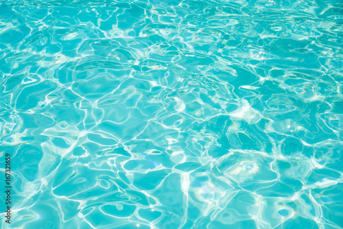 Blue and bright ripple water and surface in swimming pool , Beautiful motion gentle wave in pool