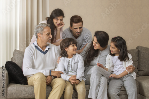 Portrait of smiling multi-generation family sitting on sofa © IndiaPix