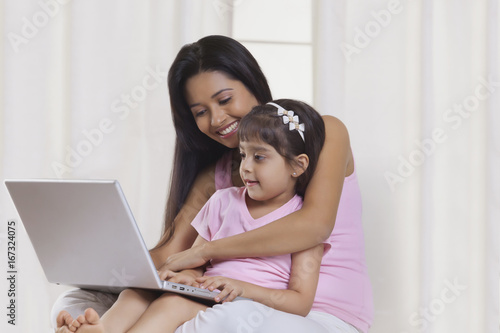 Mother and daughter with laptop