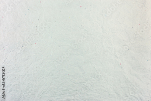 natural crumpled and creased light grey paper surface texture background with showing multicolored paper fibers