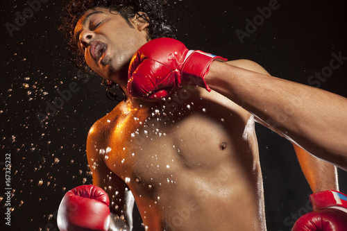 Boxer taking hit from opponent  © IndiaPix