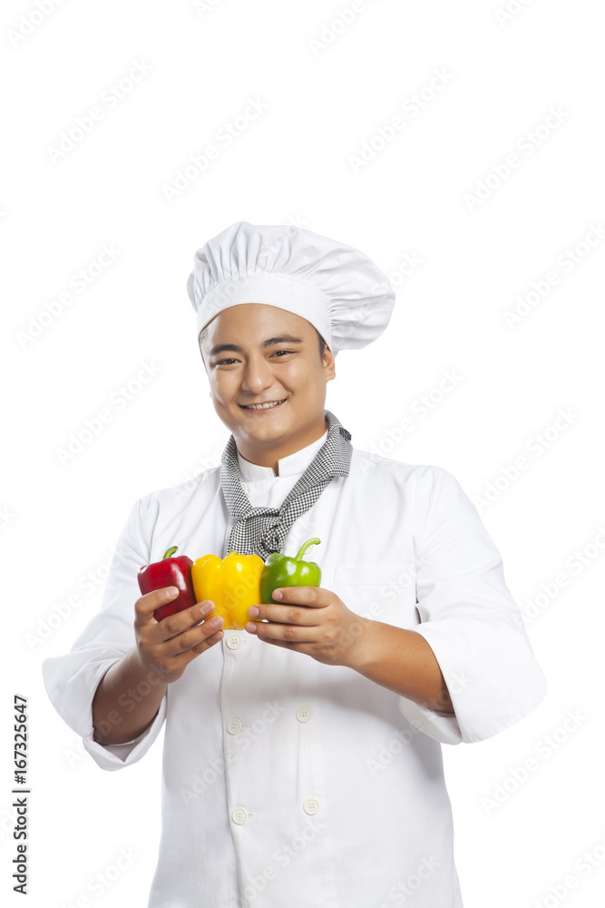 Portrait of chef holding capsicum Portrait of chef holding capsicum