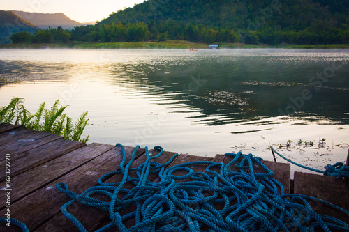 Принти на полотні Old wood waterfront terrace and rope at marine port