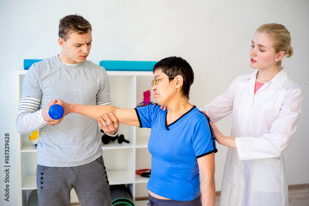 Physiotherapist helping a senior woman Physiotherapist helping a senior woman