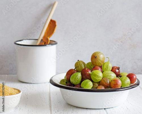 Картината върху платно Fresh gooseberries in enameled bowl