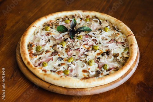 delicious pizza with meat, cheese and mushrooms