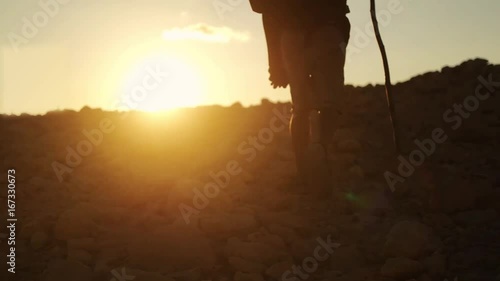 Dark skin traveler with Hiking Backpack walk in the Desert on sunset time