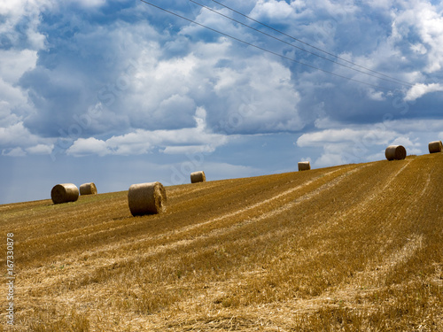 Summer Field with Hay Bales. under storm clouds.Agriculture Concept