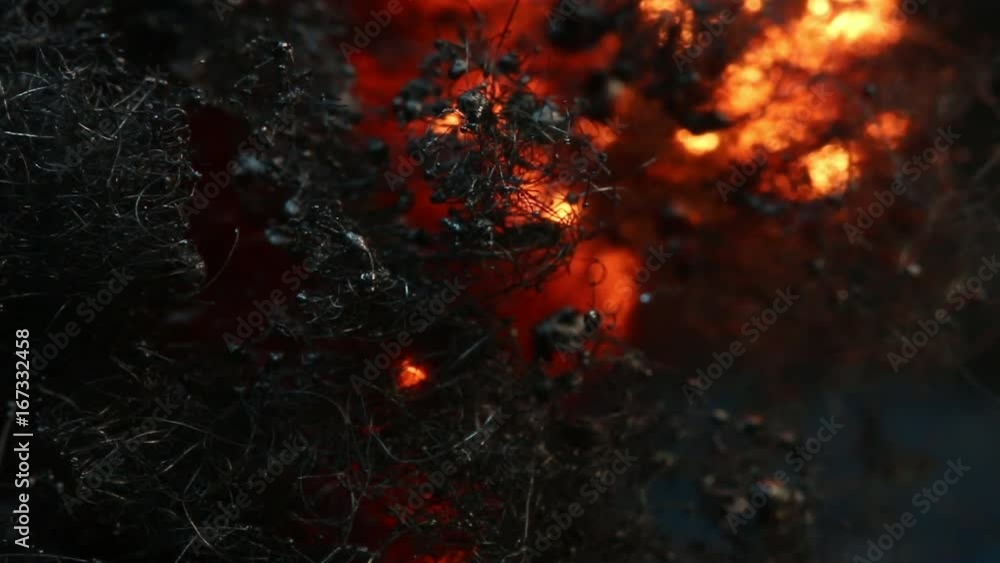 Glowing fire burns through steel wool, close up Glowing fire burns through steel wool, close up