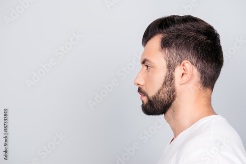 Side profile portrait of a brunet guy, isolated on pure light blue background. So trendy and stylish! Advertising and barber shop concept