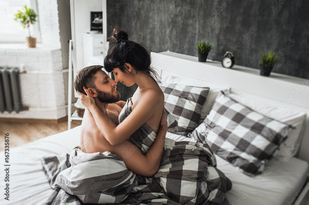 Man and woman making love in bed. Loving couple in bed having sex. Couple  in bed.