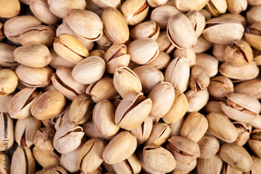 Close up of Pistachios on wooden background in studio photo. Healthy delicious snacks Close up of Pistachios on wooden background in studio photo. Healthy delicious snacks
