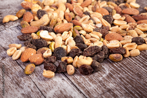 Delicious Mix of healthy raw nuts on wooden background in studio photo. Healthy organic snack