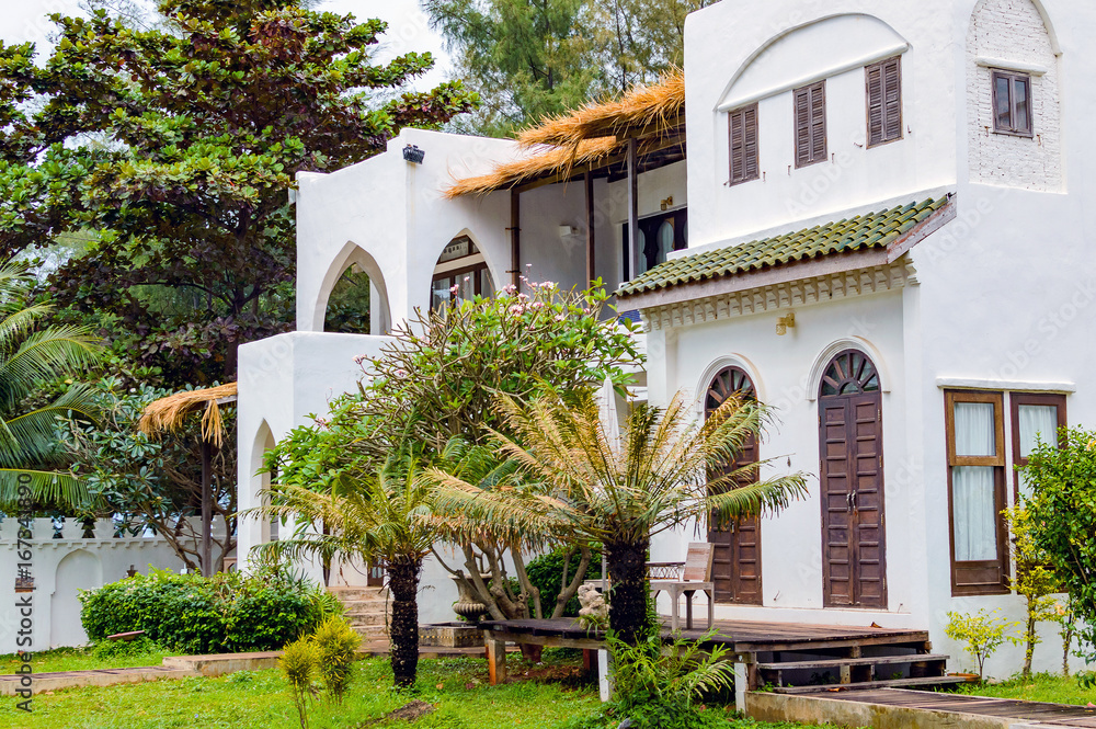 Fototapeta premium Modern and luxurious residence holiday villa house, exterior facade of building on resort. Front view. Lifestyle concept