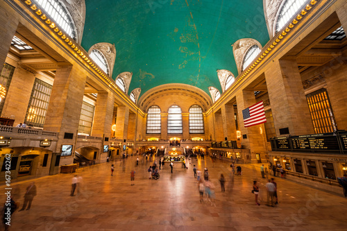 Inside view of the main hall of Grand Central Terminal Station with many peoples in motion. Picture of the big main concourse of the historic railroad station. photo