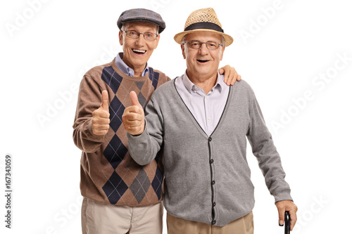 Seniors looking at the camera and holding their thumbs up © Ljupco Smokovski