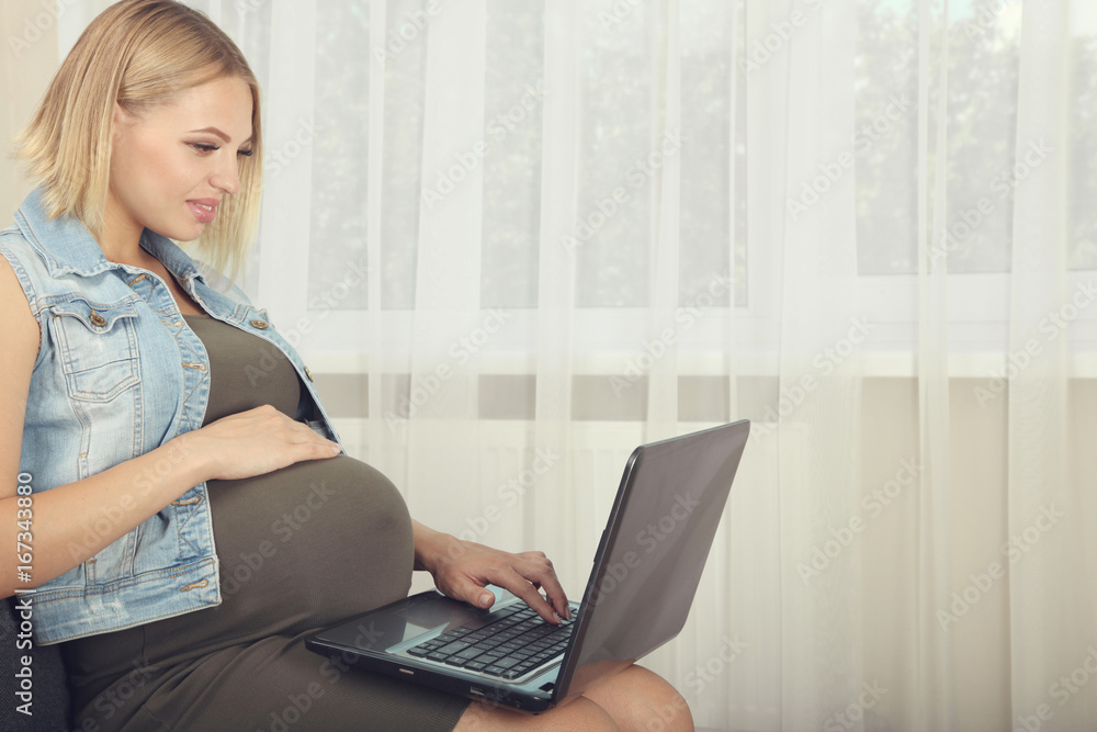 Pregnant sitting with laptop Pregnant sitting with laptop