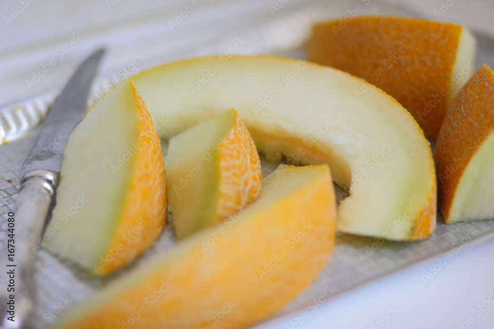 Sliced melon with an ancient knife in retro style