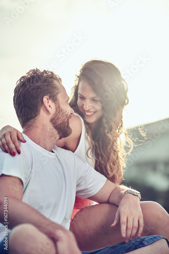 Couple sitting and cuddling at beach