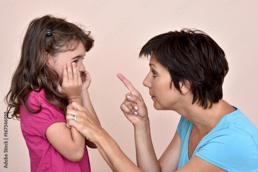 Angry mother scolding a scared daughter Angry mother scolding a scared daughter