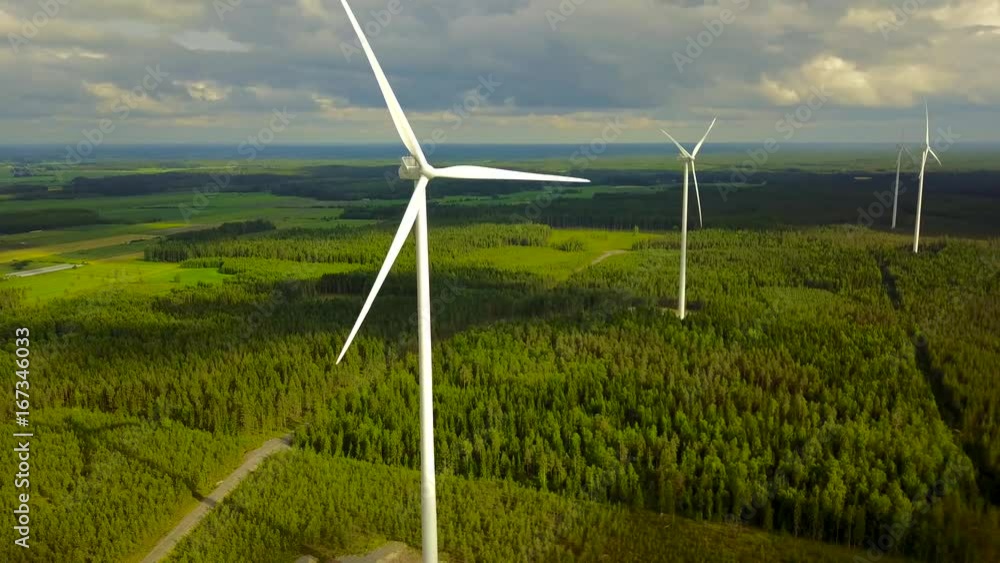 Wind turbines close-up on forest on cloudy day, 4K aerial video. Wind turbines close-up on forest on cloudy day, 4K aerial video.