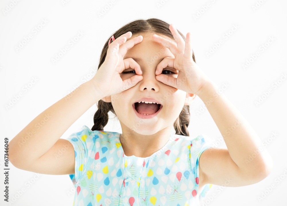 happy little girl with watching gesture happy little girl with watching gesture