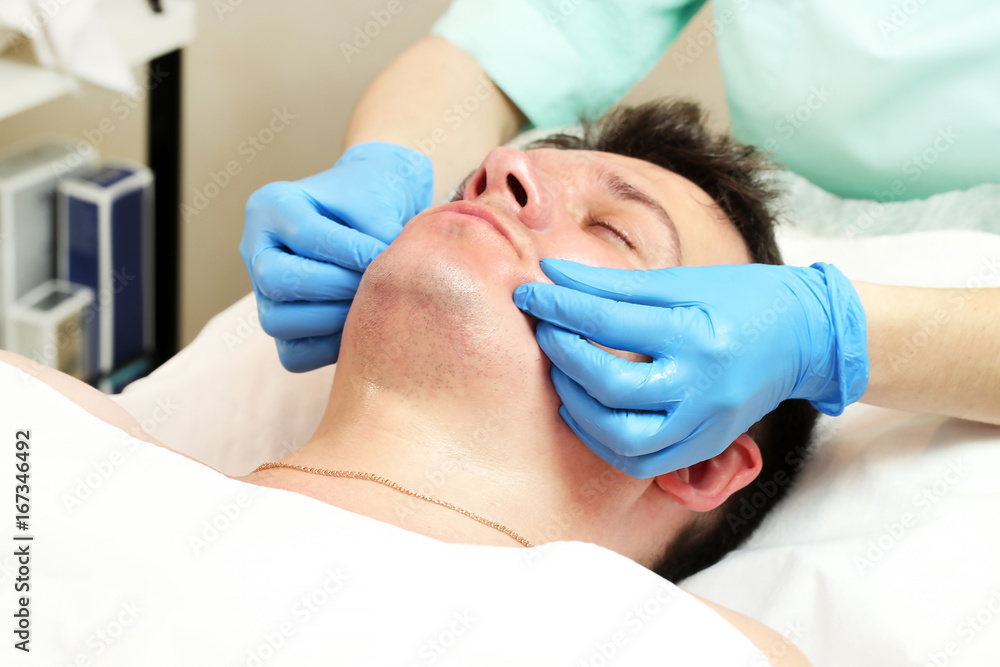 Man in the mask cosmetic procedure in spa salon Man in the mask cosmetic procedure in spa salon