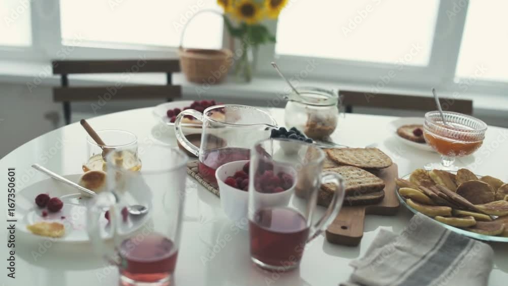 Young happy family with two kids having breakfast together at home Young happy family with two kids having breakfast together at home