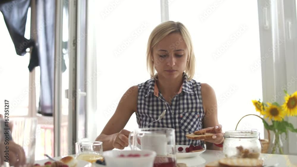 Young happy family with two kids having breakfast together at home Young happy family with two kids having breakfast together at home