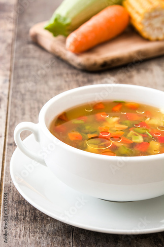 Vegetable soup in bowl on wooden table 