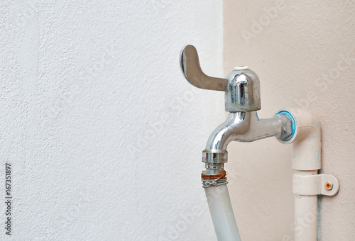 Water tap connector with rubber pipe at the wall.