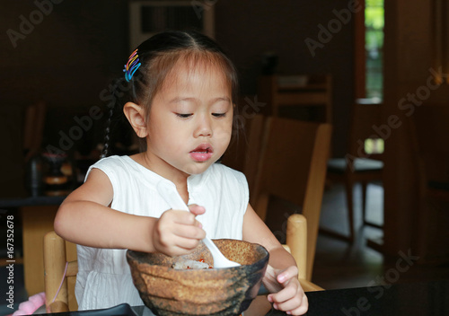 Asian kid girl eating rice delicious japanese food on table for lunch in the restaurant.