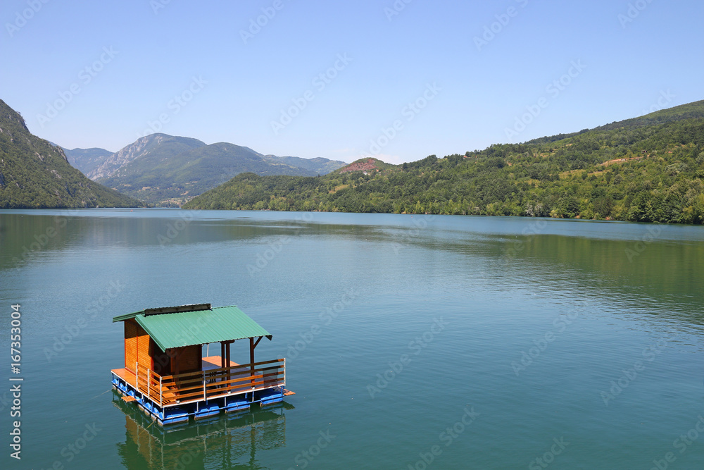 wooden house floating on Drina river Serbia