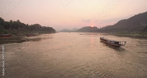 Fly By Drone Shot of Traditional Long Boat on Mekong River, Luang Prabang, Laos
