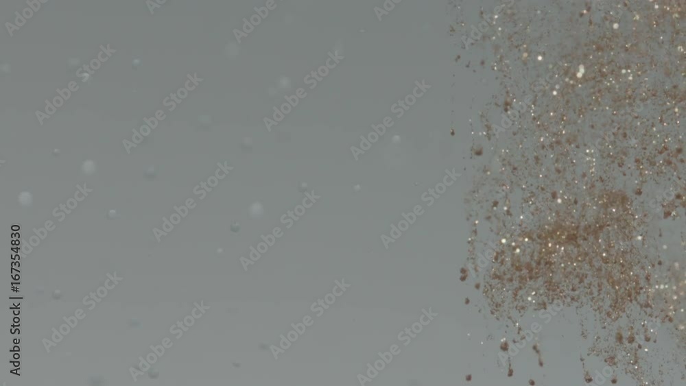 Glitter and bubbles in water, slow motion Glitter and bubbles in water, slow motion