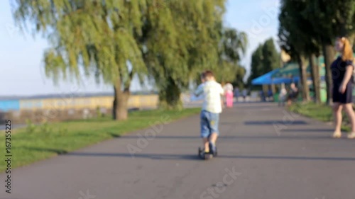 Wallpaper Mural A happy child is riding a scooter Torontodigital.ca