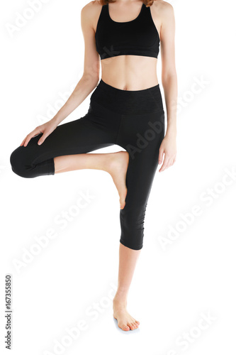 Young woman in beautiful yoga pants on white background