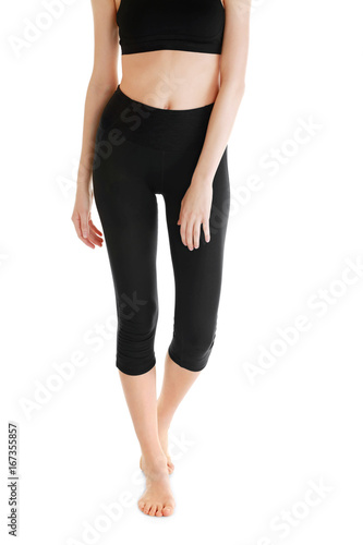 Young woman in beautiful yoga pants on white background
