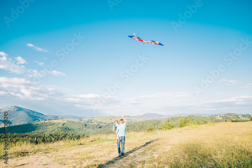 man plays with Kite in the sky