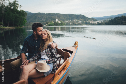 Young Couple Relaxing On A Boat Enjoying Sunny Day
