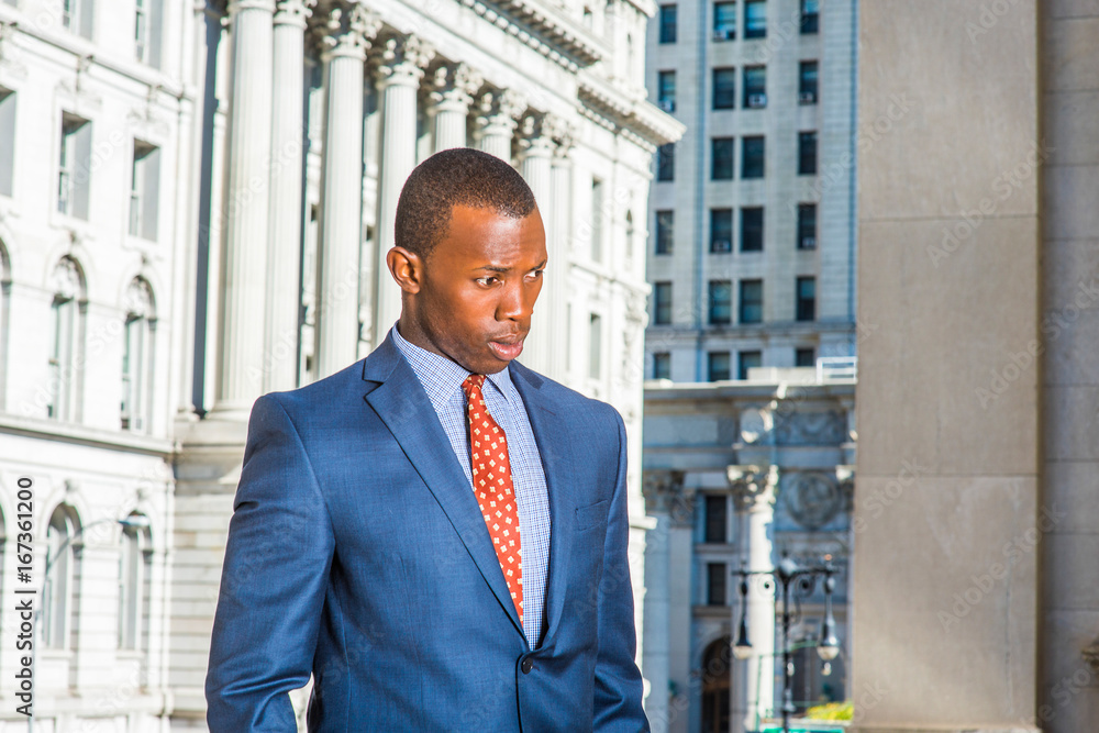 Young African American Businessman thinking outside office in New York Young African American Businessman thinking outside office in New York