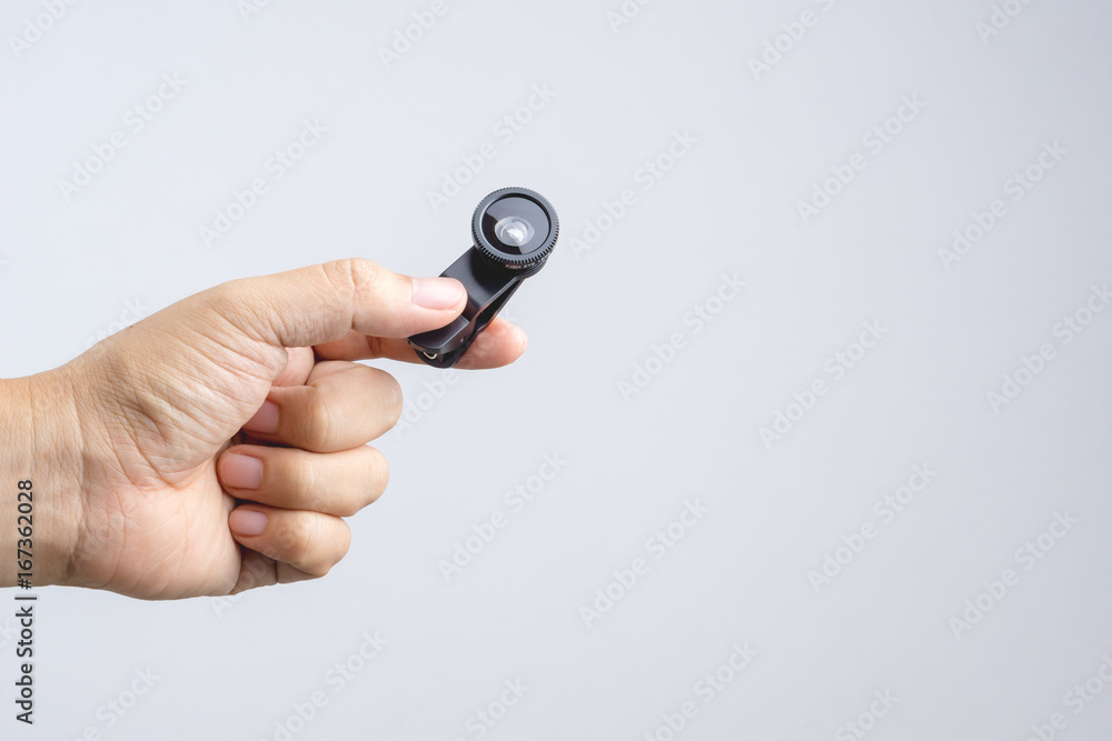 Hand holding with extension lens for smart phone camera Hand holding with extension lens for smart phone camera