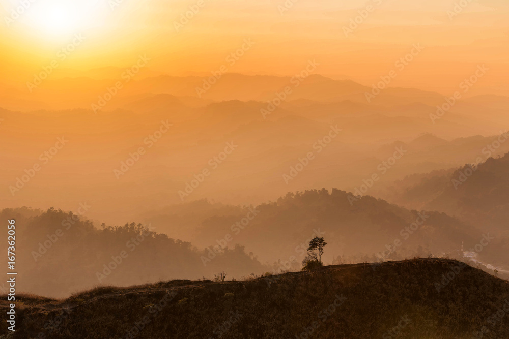    high angle viewpoint over tropical rainforest mountains in Thailand on sunset