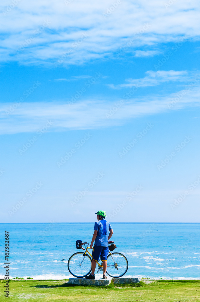 Fototapeta premium Cyclist and Bicycle on Chishintan Beach, Hualien, Taiwan. Photo shot on Oct 23, 2015